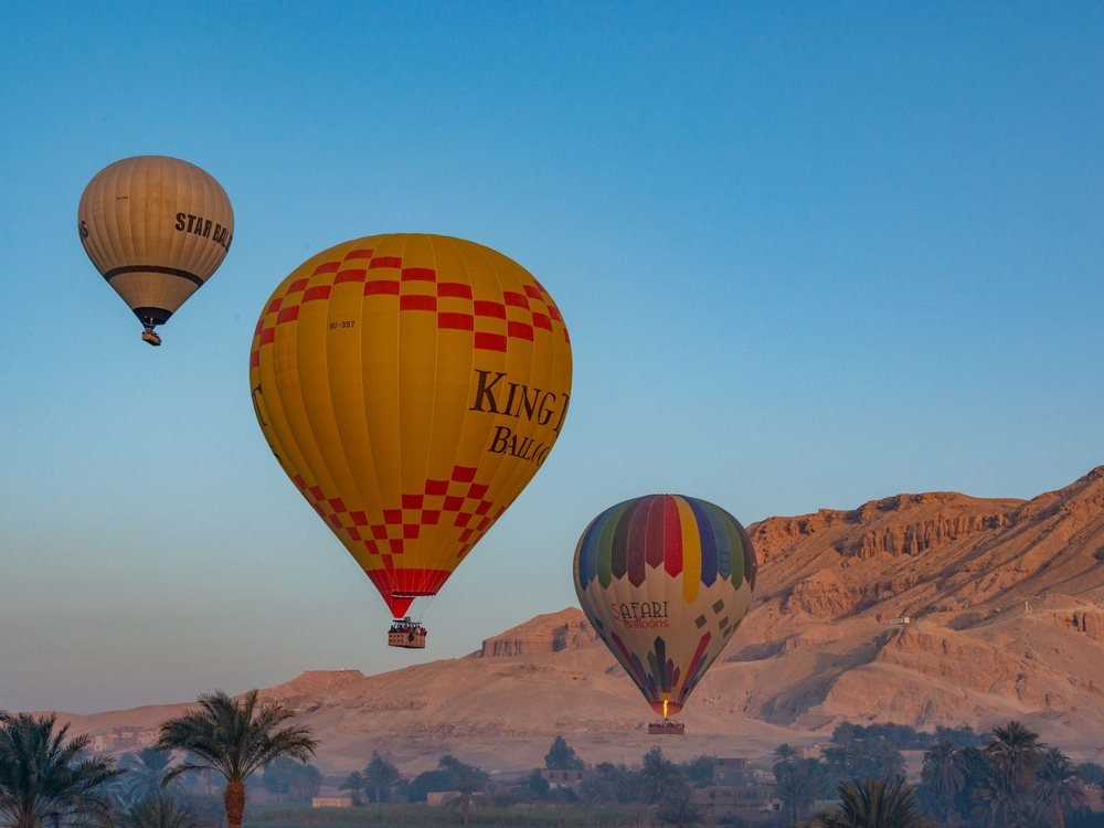 Balloons preparing for launch at sunrise on the west bank of Luxor.