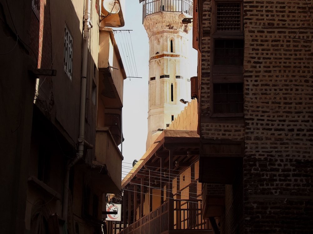 A minaret rising above the narrow streets and traditional brick houses of Rashid.