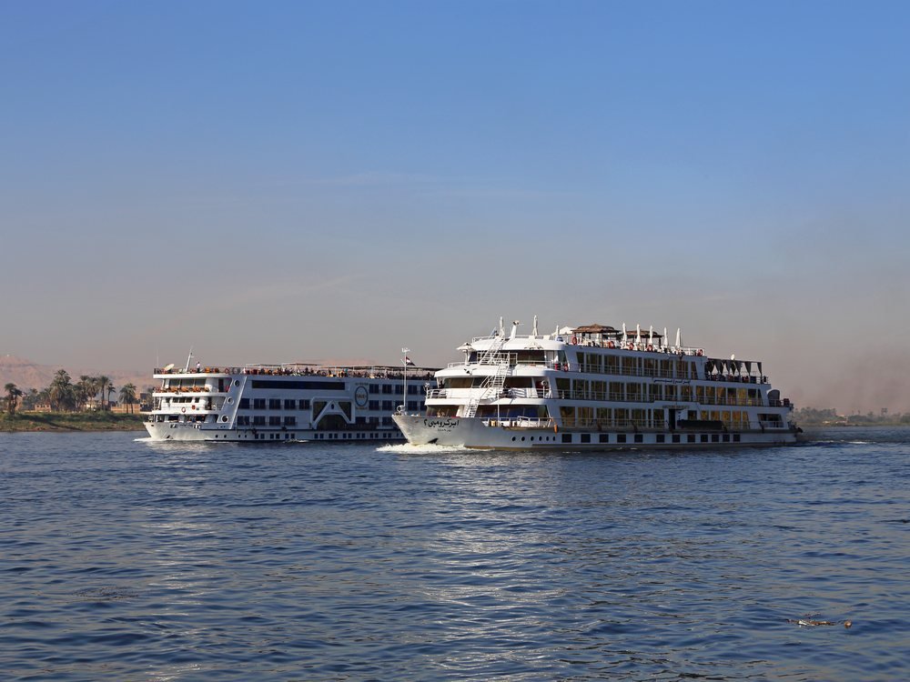 A Nile cruise ship underway near Luxor — the thread that connects Egypt's grand tour from Cairo to Aswan.